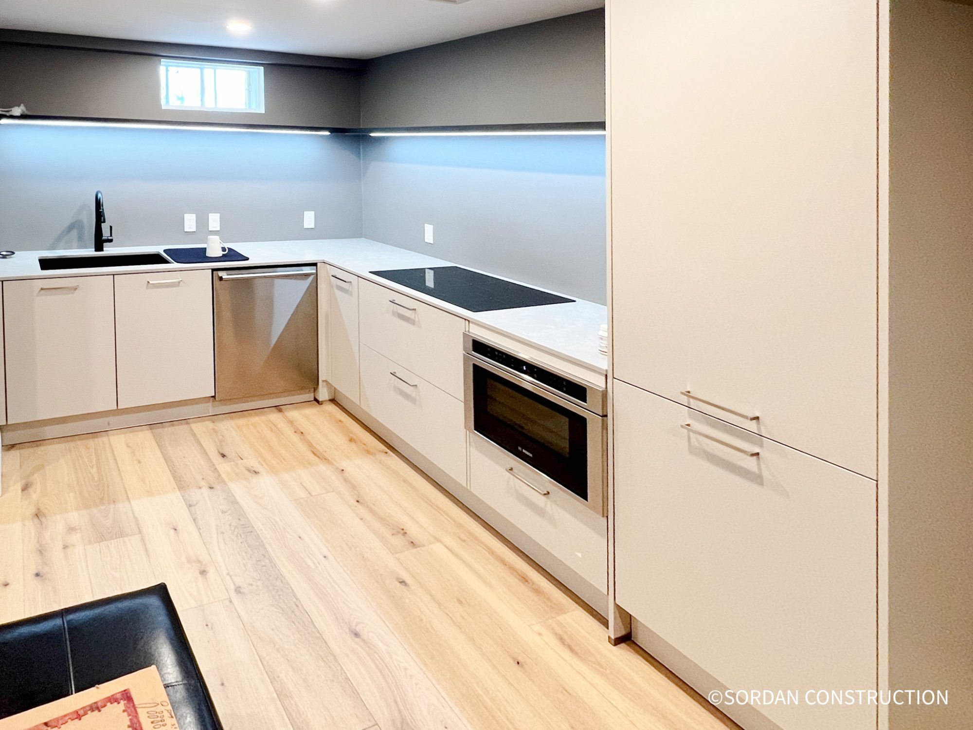 Modern kitchenette installed in a finished basement ADU for rental income